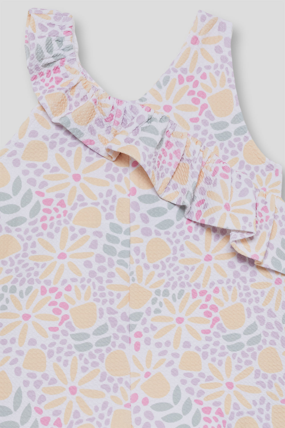 Mono niña estampado con volante en el pecho