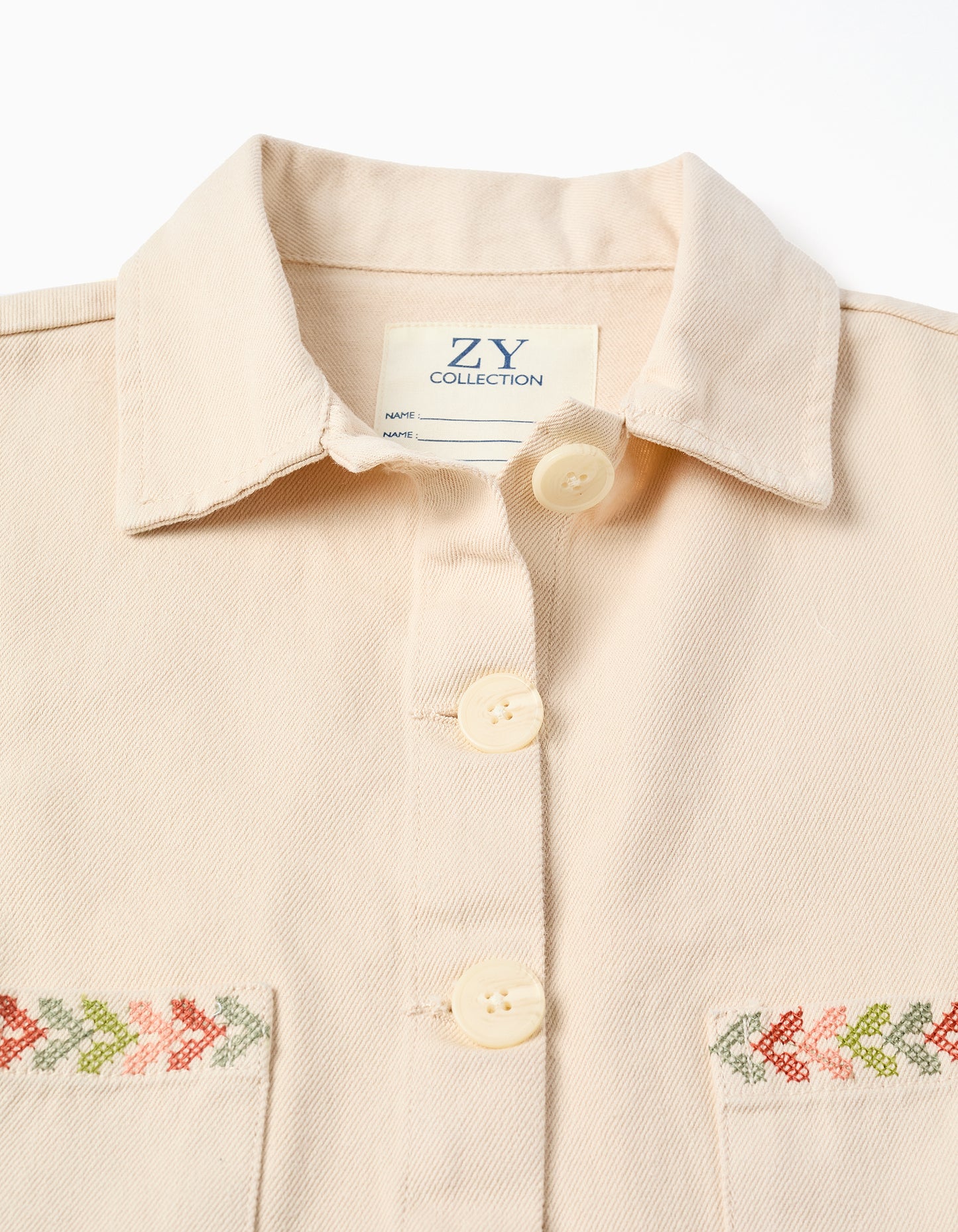 Chaqueta niña beige con bordado decorativo